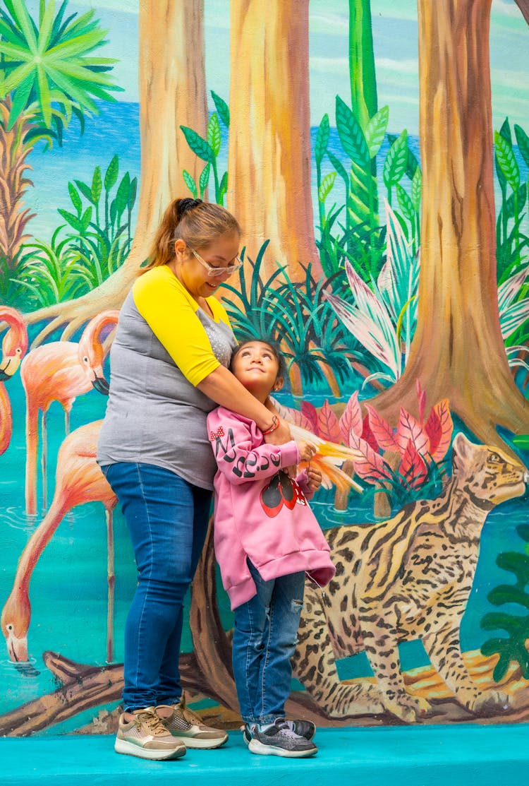 Mother With Daughter Against Mural