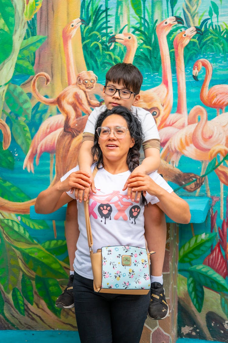 Woman Carrying Son Piggyback