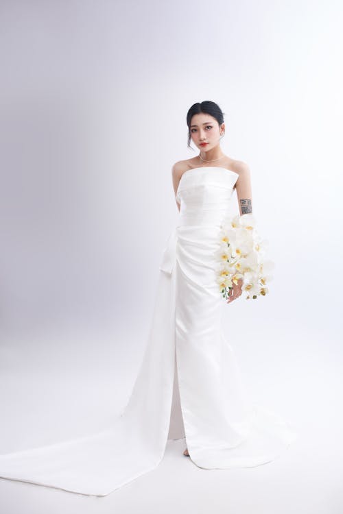 Studio Shot of a Beautiful Young Brunette in a White Dress