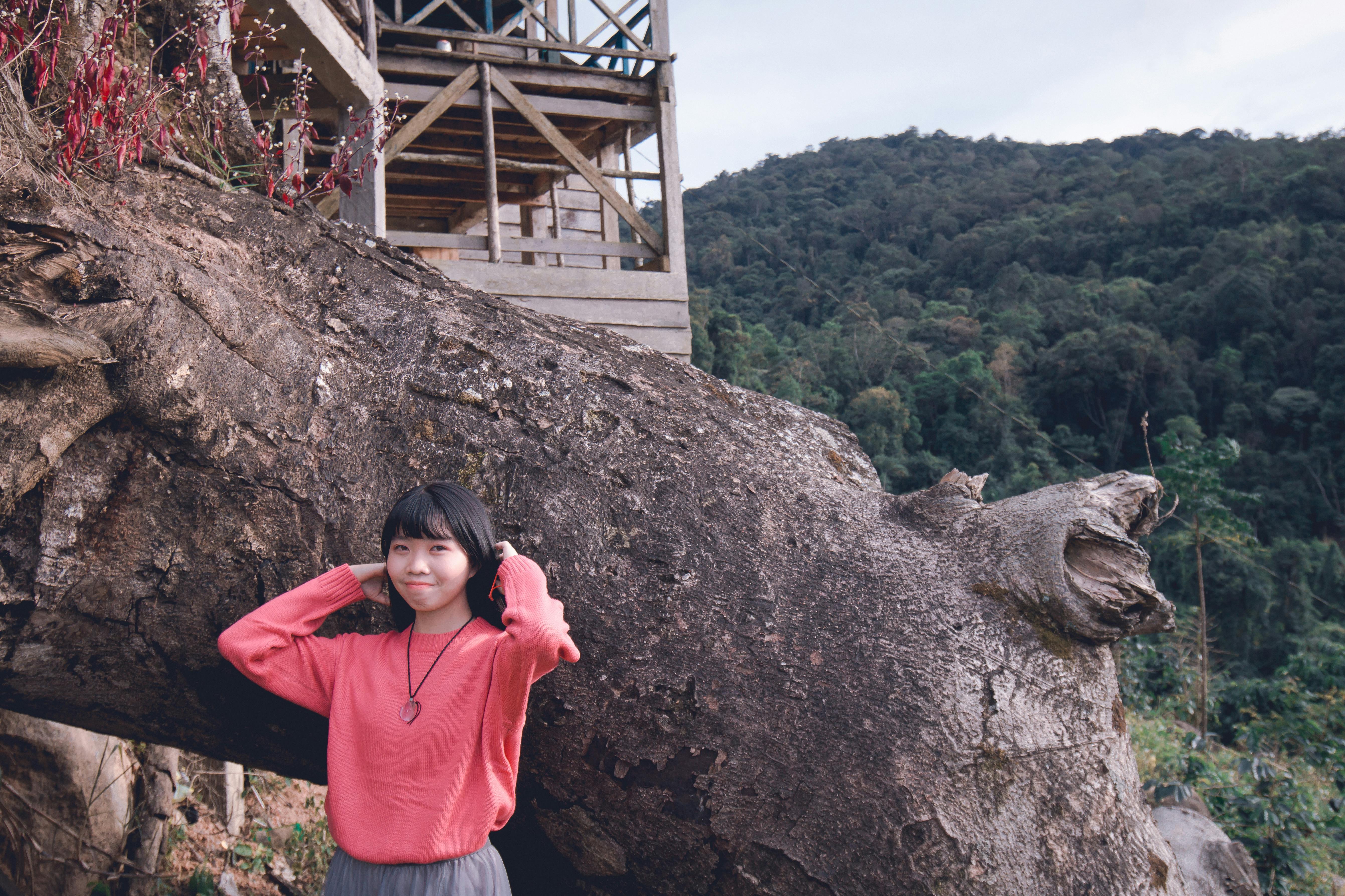 Woman Posing for Photo Shoot in Front of a Huge Tree