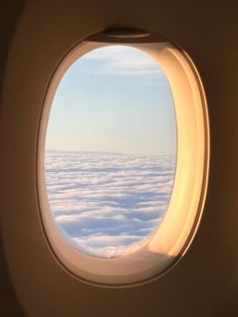 Serene view of clouds from an airplane window, capturing the essence of flight and travel.