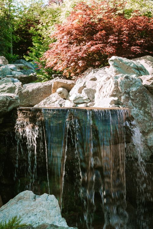 Free Serene waterfall flowing over rocks surrounded by lush greenery in Krasnodar, Russia. Stock Photo