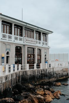 Seaside view of Moda Iskelesi's historic building with rocky coast in Istanbul.