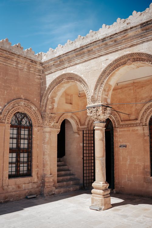 Free Explore the intricate details of 19th-century Ottoman architecture with arched columns and stone facade. Stock Photo