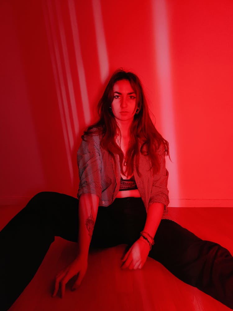 A Portrait Of A Woman In Red Light