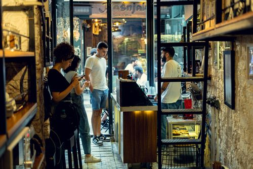 Free Cozy café interior in İstanbul, Türkiye, with patrons enjoying their coffee and ambiance. Stock Photo