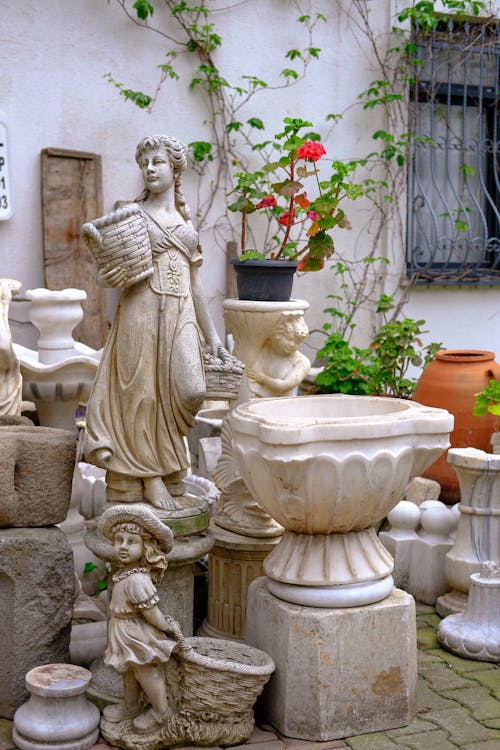 A bunch of statues and pots on a patio