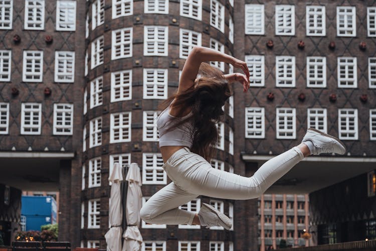 Young Artist In The Air During A Street Performance On Inner Courtyard Of Sprinkenhof