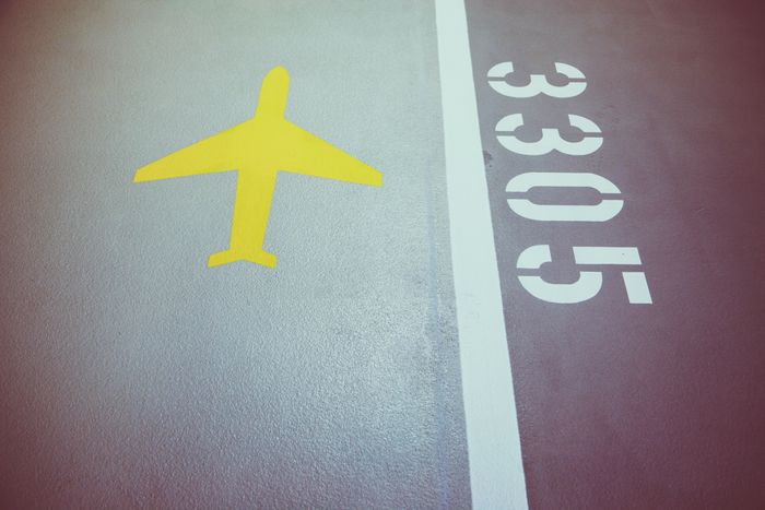 Close-up of runway markings and painted numbers on airport pavement