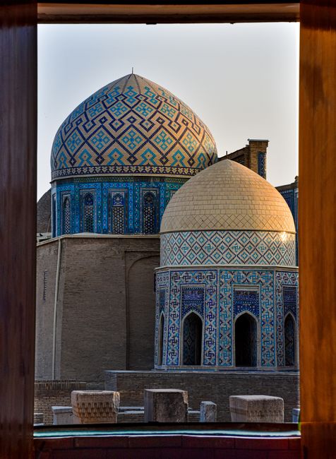 Detailed view of stunning domes in Samarkand, capturing intricate mosaics and traditional Uzbek architecture at sunset.