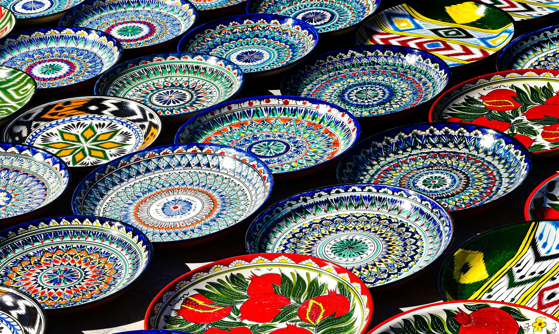 Vibrant hand-painted Uzbek ceramic plates showcasing traditional patterns in Bukhara, Uzbekistan.