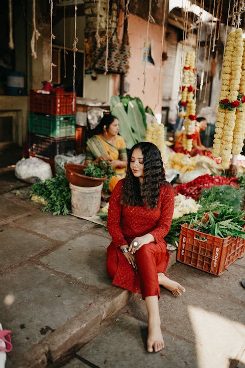 Woman Sitting on Ground and Posing