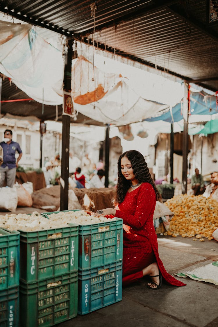 Woman Crouching Near Boxes With Vegetables On Bazaar