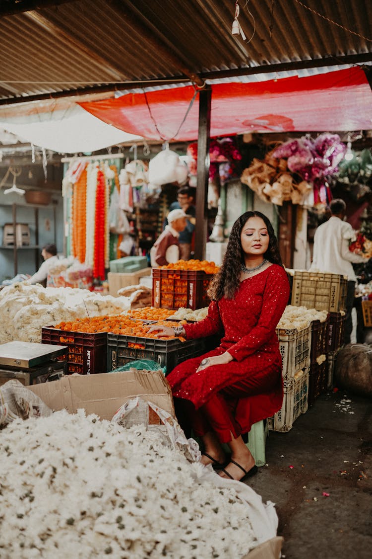 Woman Posing Among Fruit And Vegetables On Bazaar