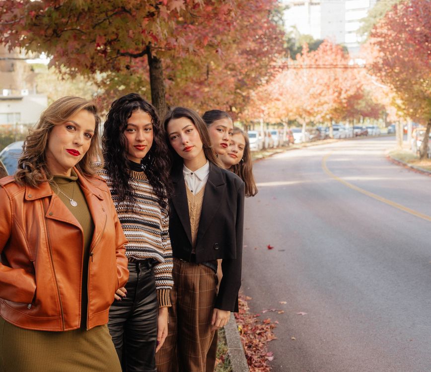 Diverse group of women models in stylish layered monsoon outfits