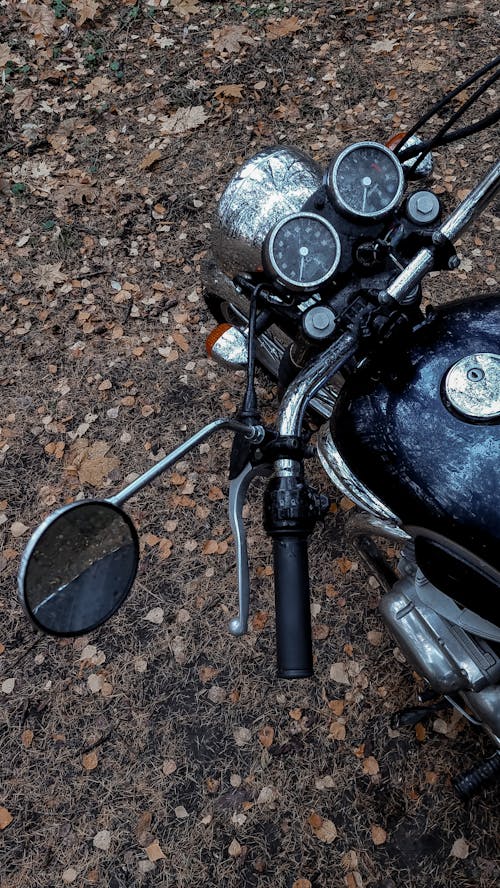 View of a Motorbike Parked on a Dirt Road 