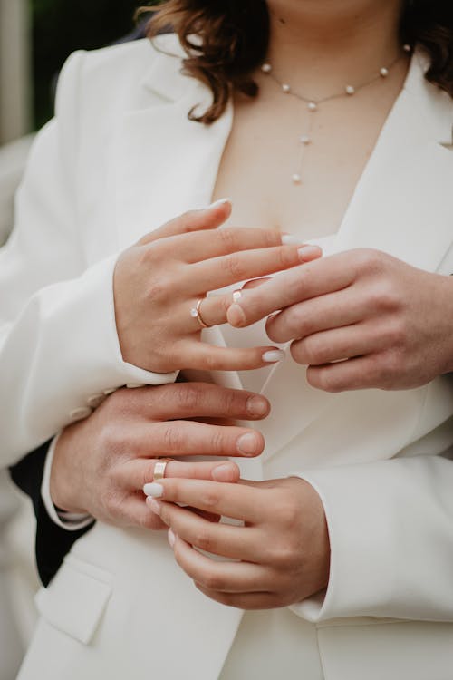 Embracing Newlyweds Showing Wedding Rings