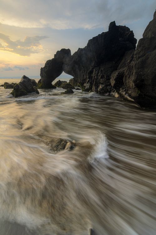 Free Eroded rock formations on the shore of Jawa Barat, Indonesia during sunset. Stock Photo