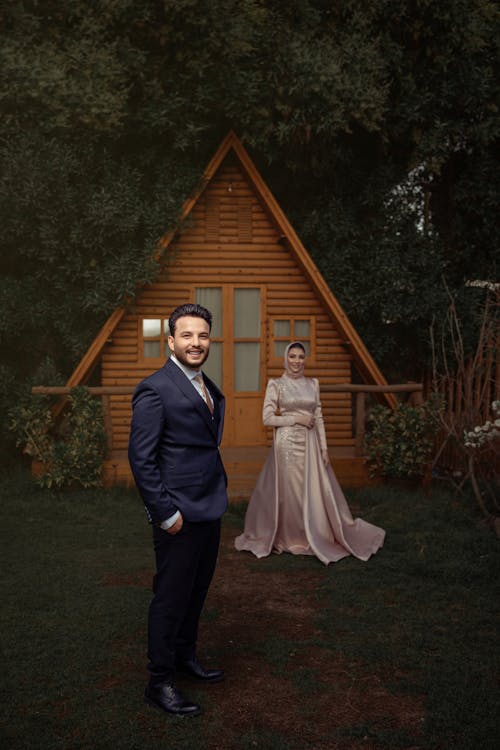 Bride Wearing a Traditional Dress and Hijab and Groom in a Tuxedo