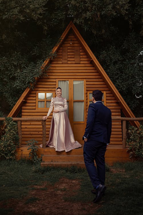 Newlyweds Posing by Tourist Rural Cottage