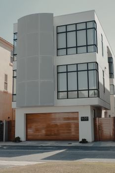 Contemporary residential building with sleek facade and garage, ideal for urban living.