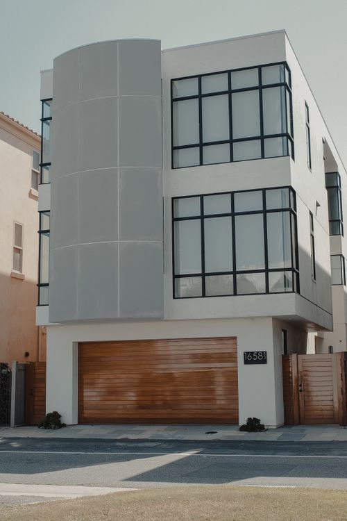 Free Contemporary residential building with sleek facade and garage, ideal for urban living. Stock Photo
