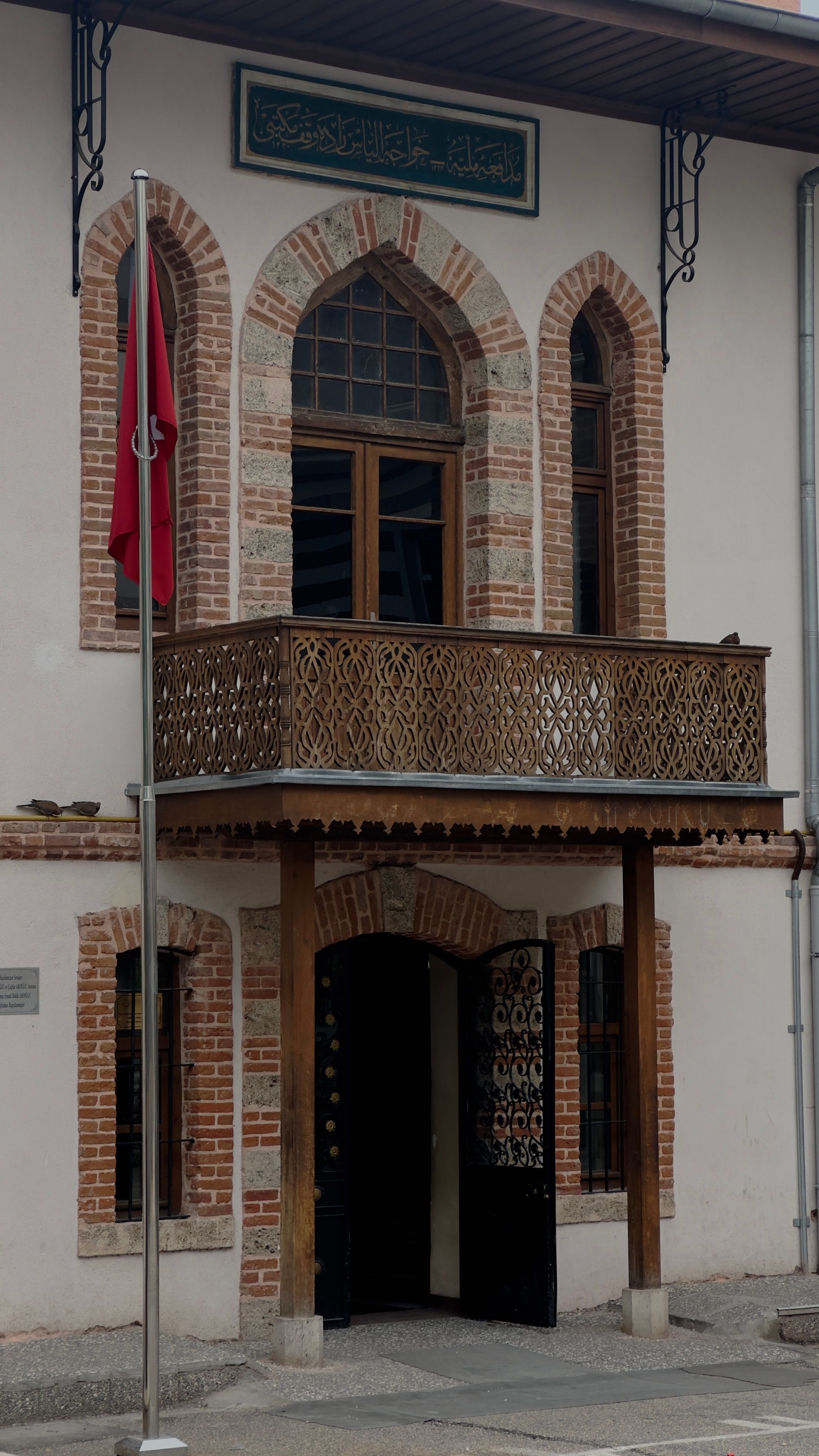 Beautiful facade of a historic building in Bursa, Turkey with ornate balcony and arched windows.