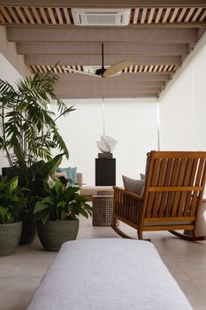 Contemporary lounge area with wooden furniture and lush plants, creating a soothing indoor environment. - Fotografer Sidoarjo