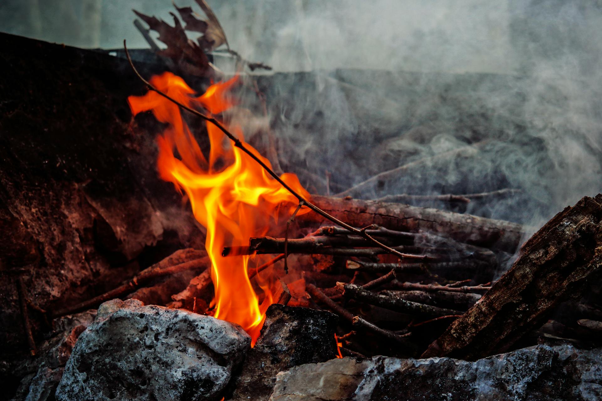 Burning Sticks Beside Rocks