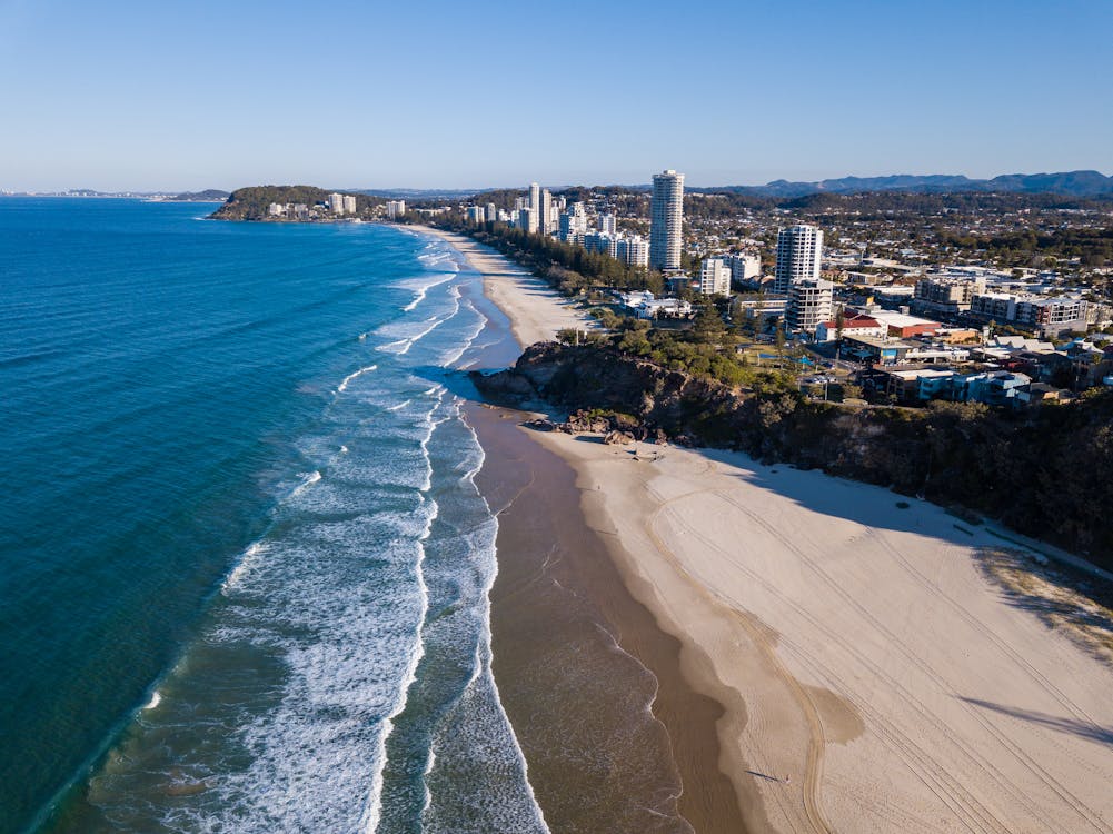 Free Stunning aerial view of coastline with beaches, city skyline, and scenic ocean. Stock Photo