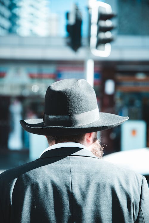 Selective Focus Photography Of Man Wearing Fedora Hat