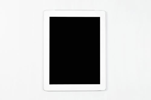 Flat lay of White Tablet isolated Empty back screen on white background. Mockup of modern tablet.