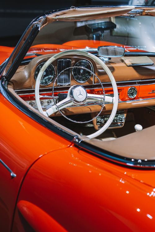 Free Close-up of a vintage red cabriolet's steering wheel and dashboard detailing. Stock Photo