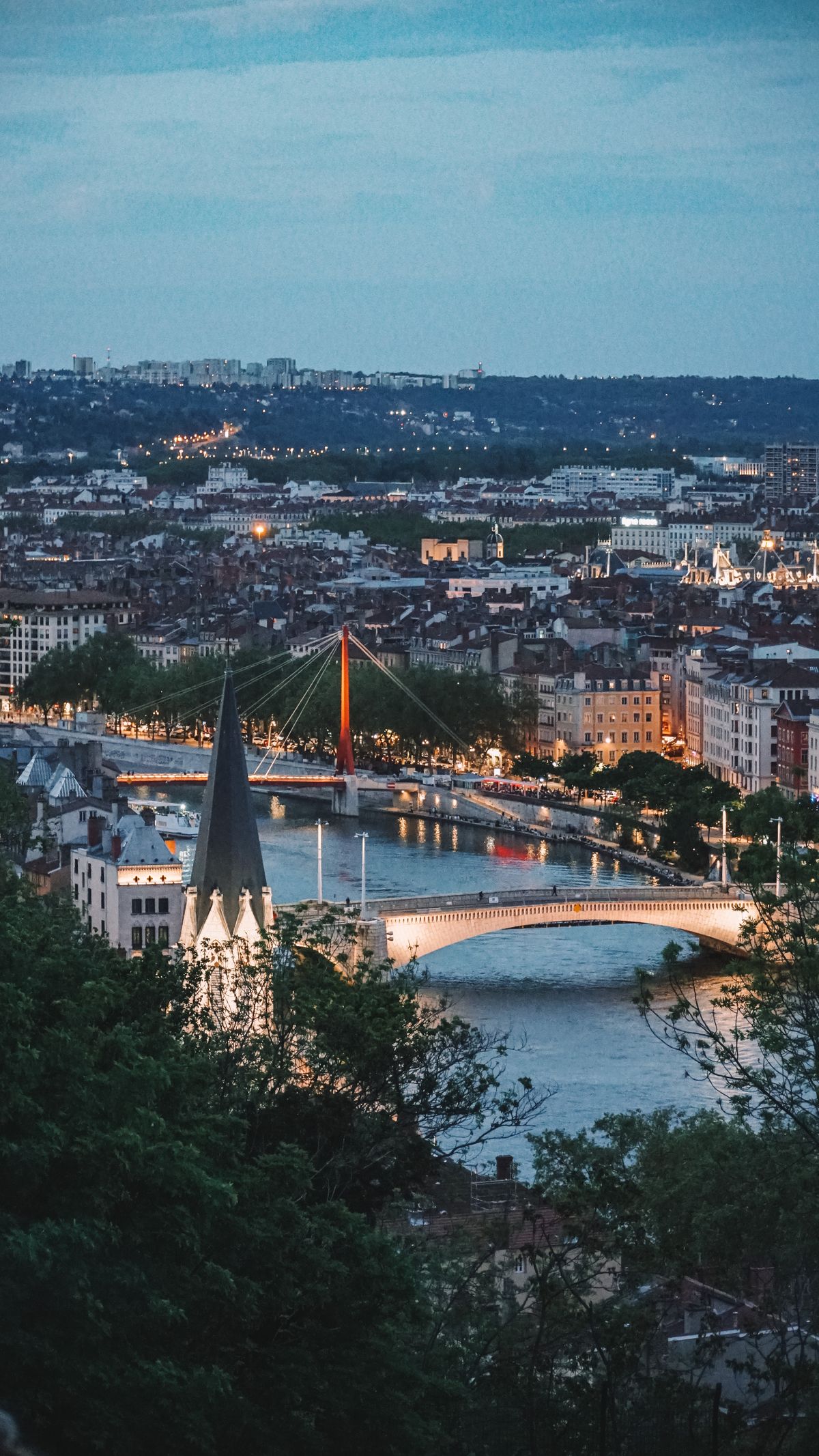 The Saône river at blue hour with a lit footbridge