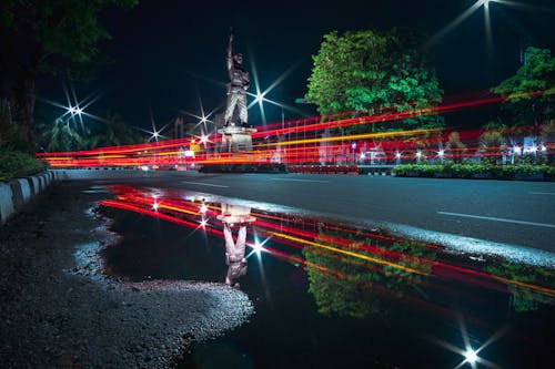 Lights around Street near Statue at Night