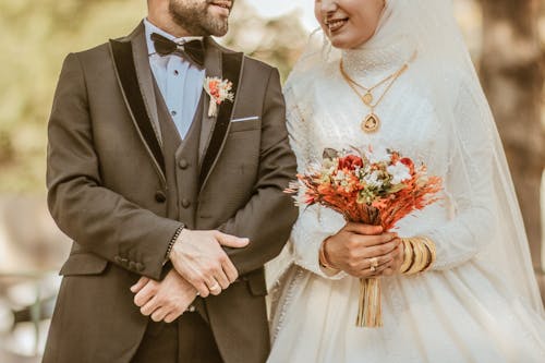 Newlyweds Together with Flowers Bouquet
