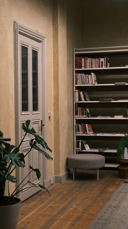 A Room with a Wooden Floor and a Bookcase 