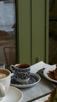 Elegant café scene with cappuccino and croissants on a marble table