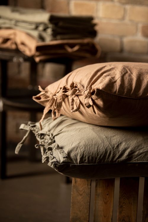 Free Rustic charm with handmade pillowcases on wooden stools, perfect for cozy interiors. Stock Photo