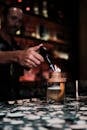 Bartender with Burner Making Cocktail at Bar