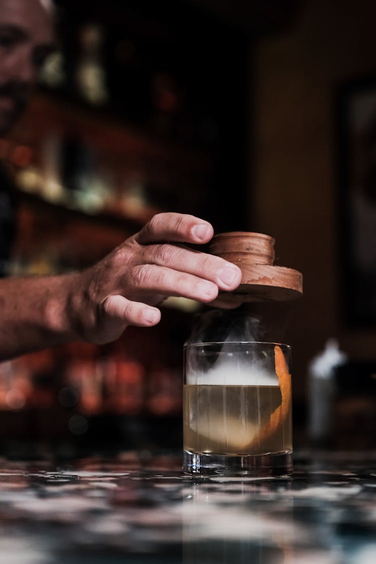 Close-up Of Bartender Making Cocktail At Bar