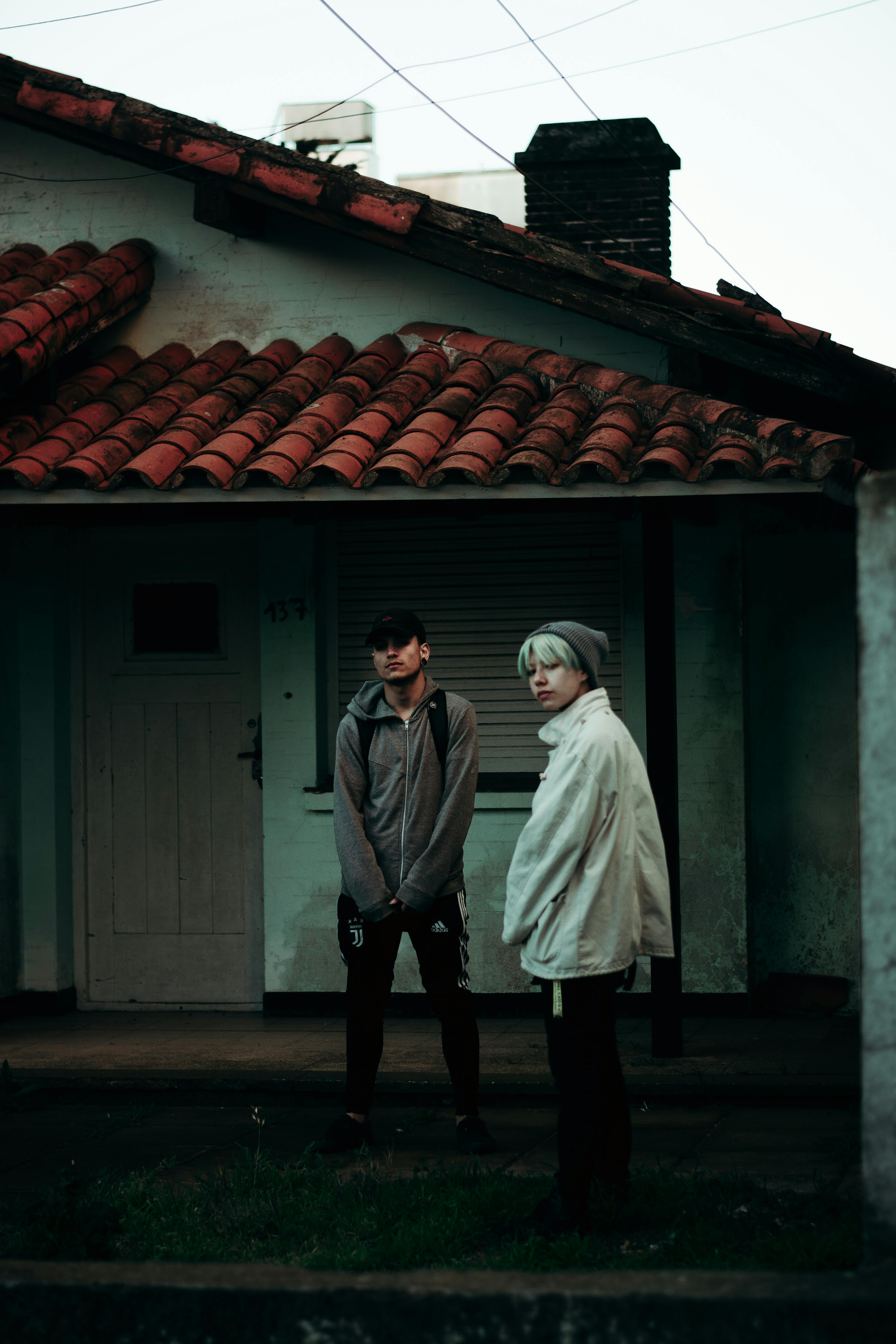 couple standing near old house