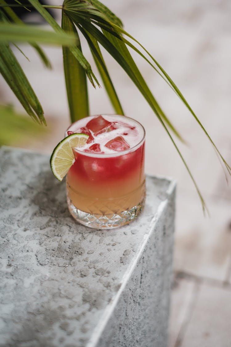 Cold Cocktail In Glass With Lime Slice