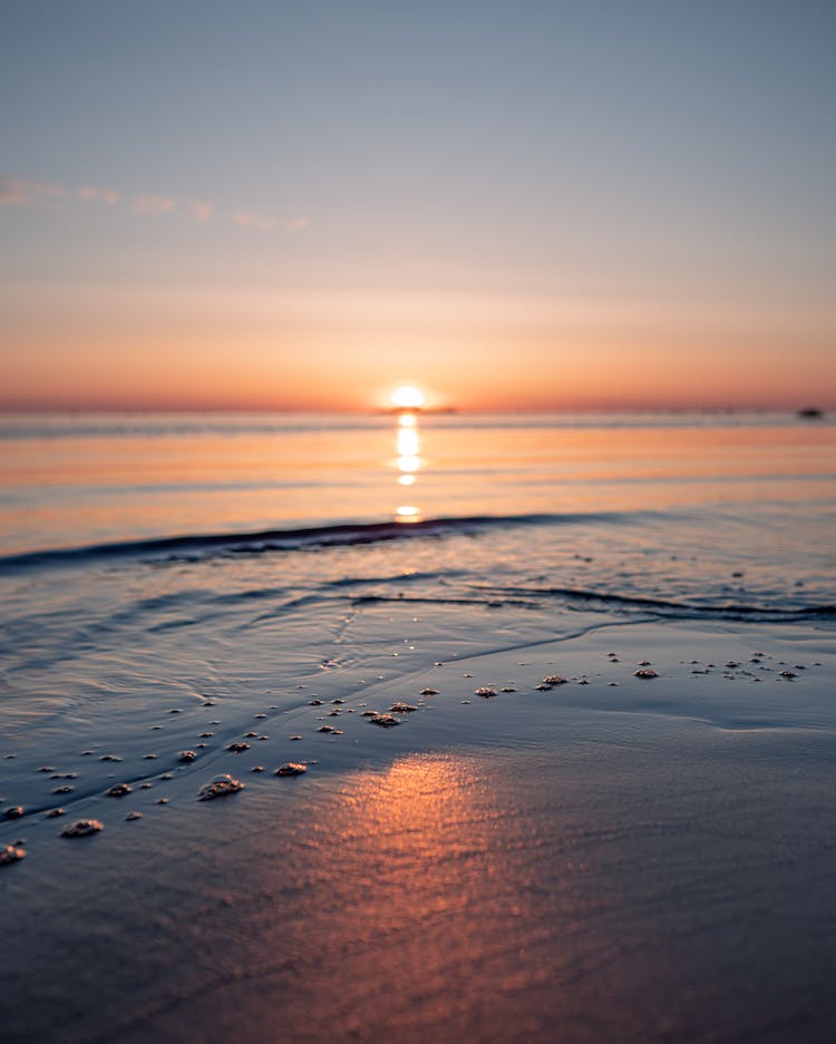 Sun Setting On Horizon On Seashore