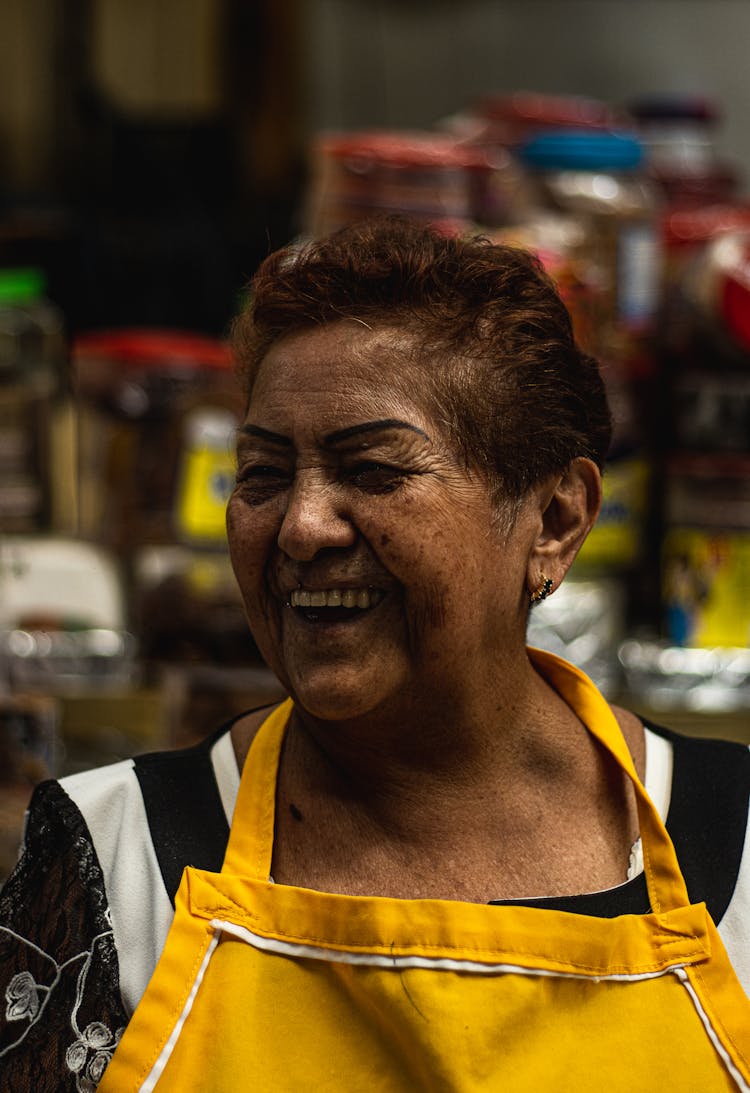 Candid Portrait Of An Elderly Woman Wearing An Apron 