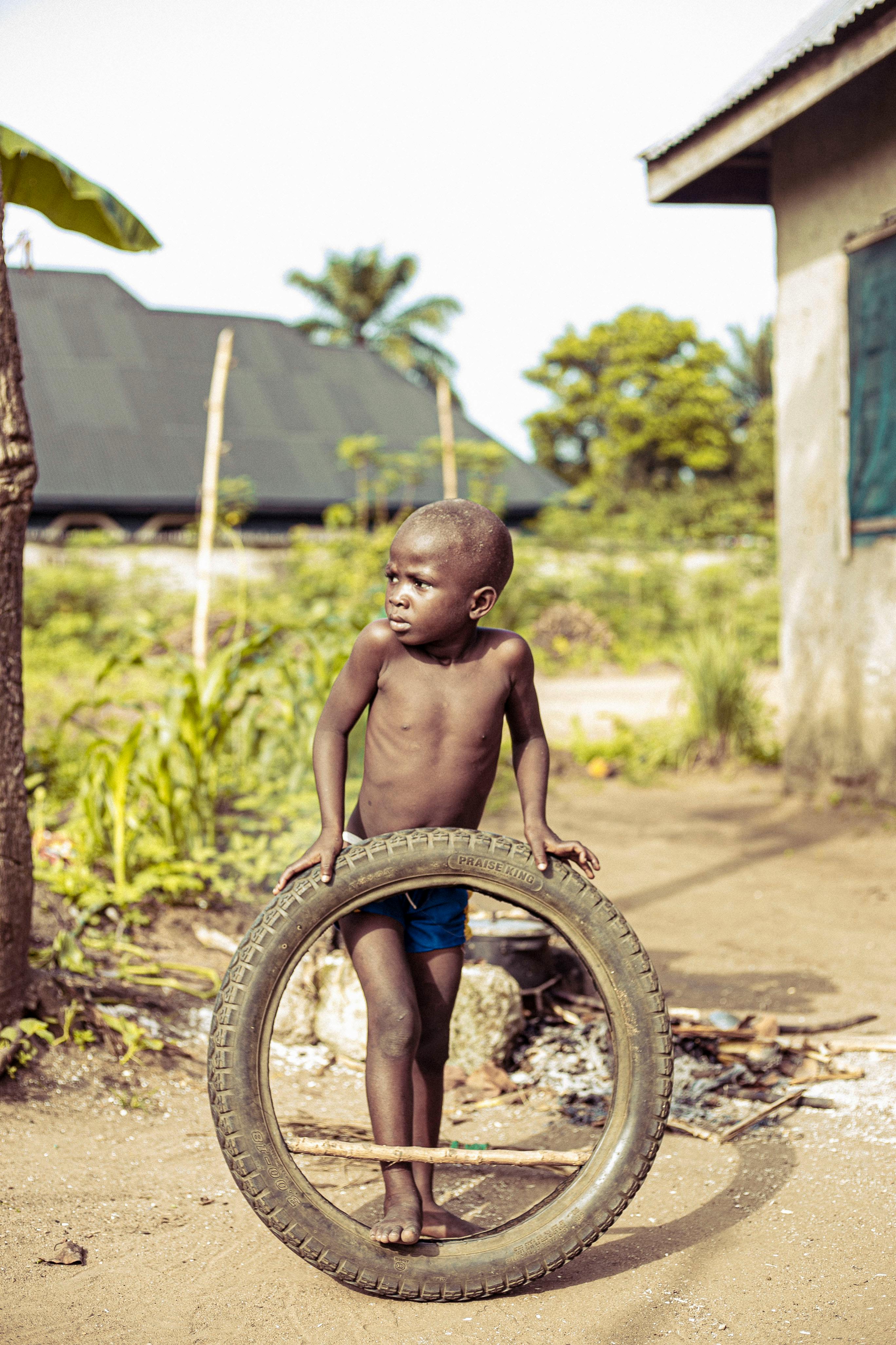 african boy holding a tire