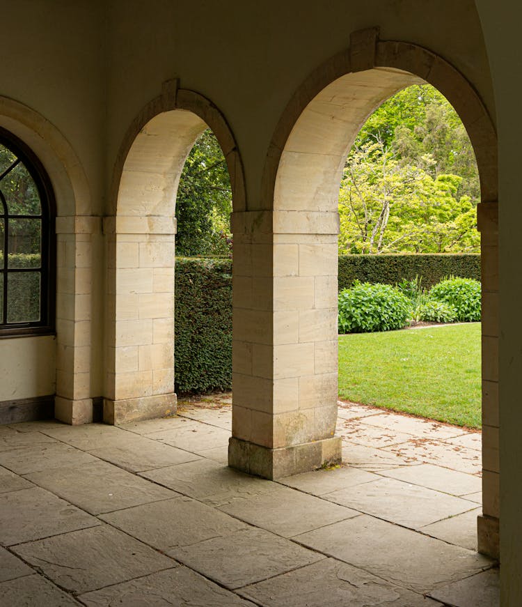 Photo Of Arcades And Green Lawn On The Yard