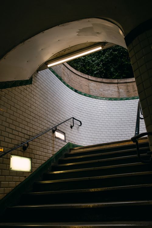 Free Vertical shot of a subway exit with elegant brickwork and contrasted lighting. Stock Photo