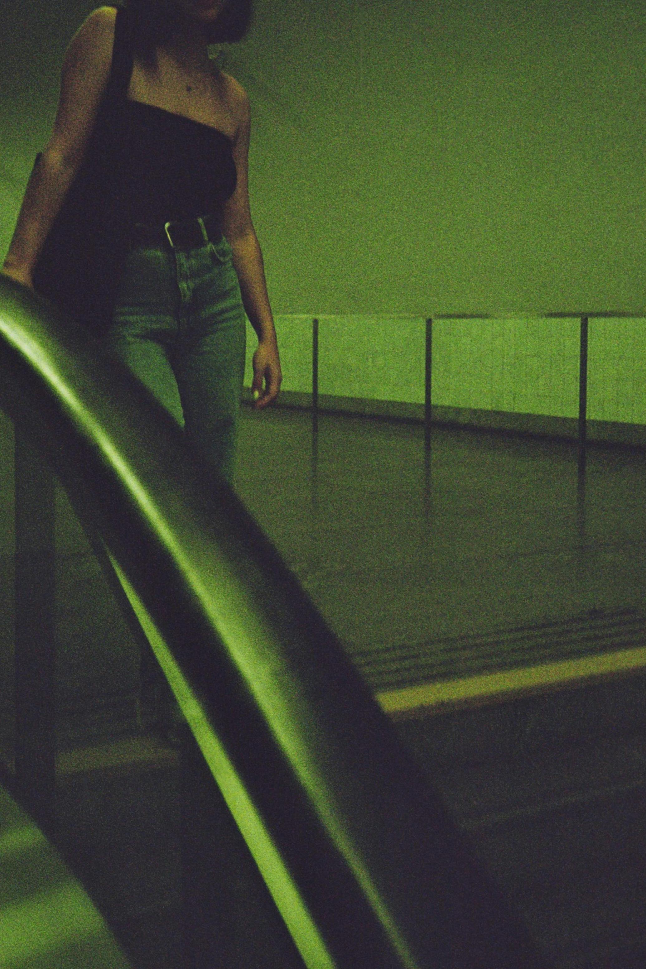Free Film-inspired portrait of a woman on an escalator in Porto, Portugal. Stock Photo
