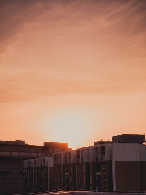 Free Dramatic sunset over Tokyo's residential skyline, creating a warm urban ambiance. Stock Photo